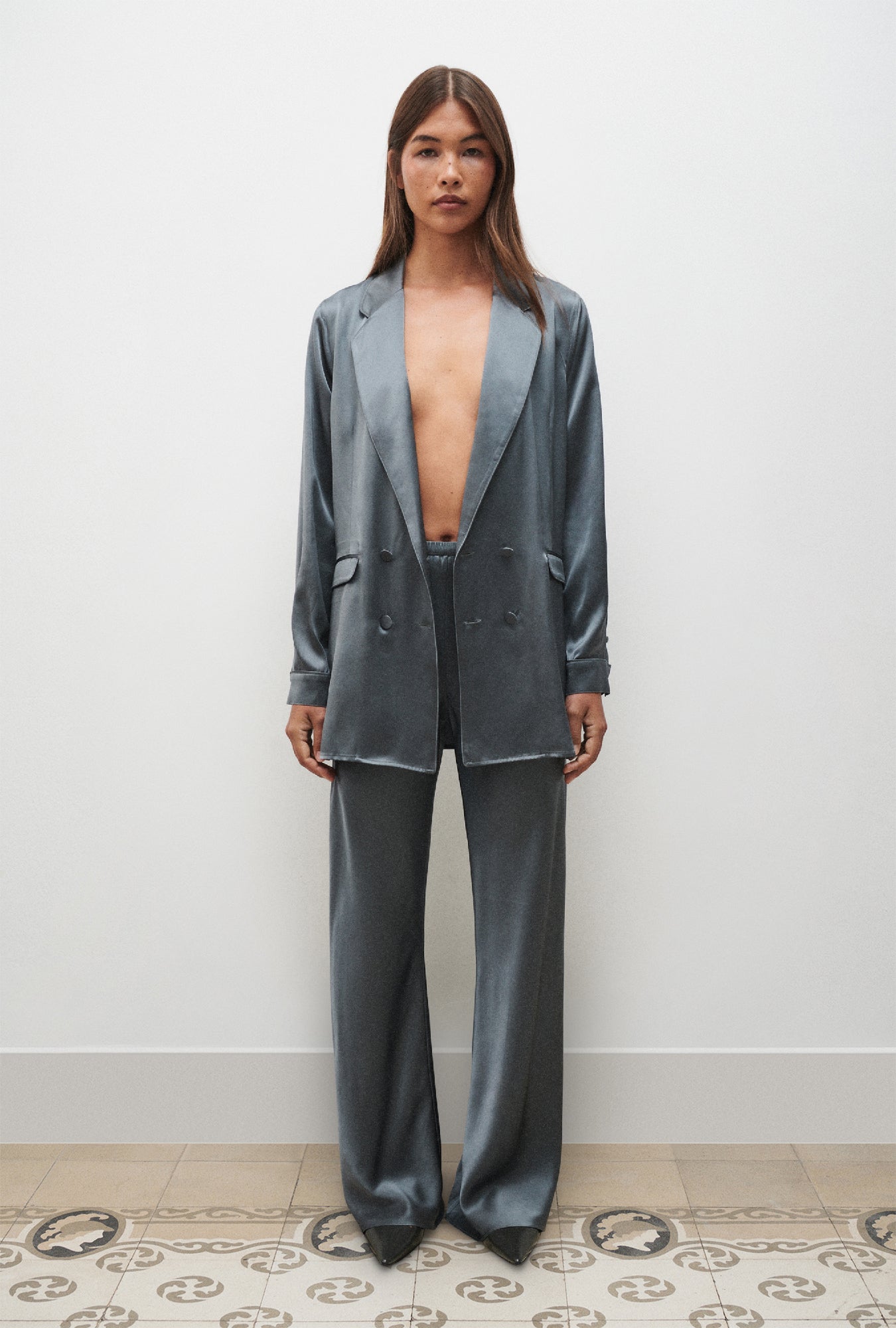 Image of a model wearing Pants. Product name - Bias Cut Pants Slate in Slate colour by brand - Silk Laundry