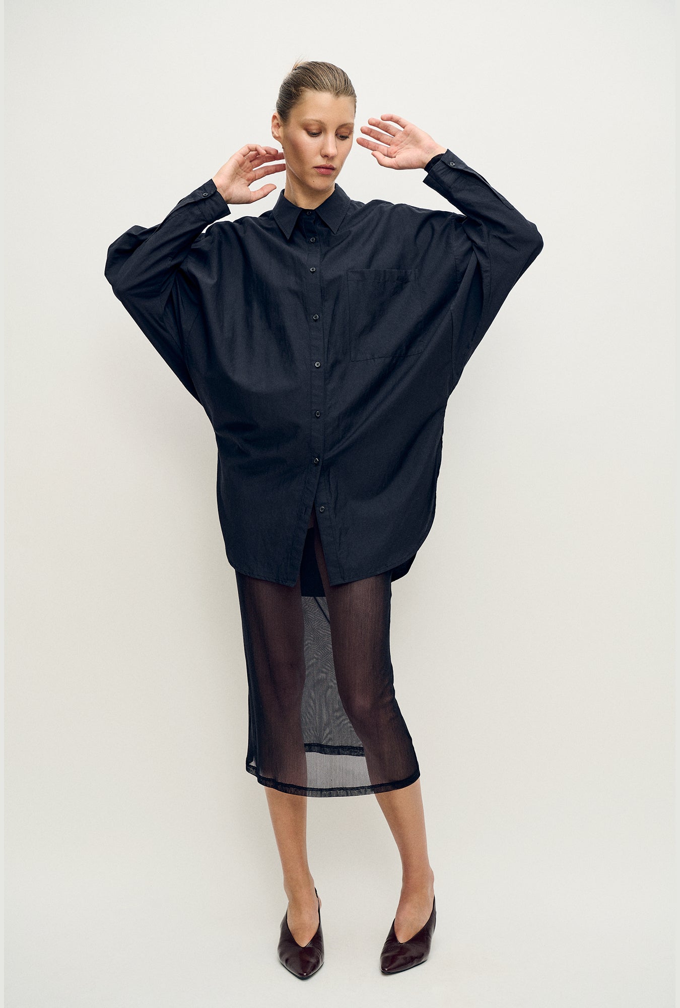 Image of a model wearing Skirts. Product name - Mesh Skirt Black in Black colour by brand - Silk Laundry