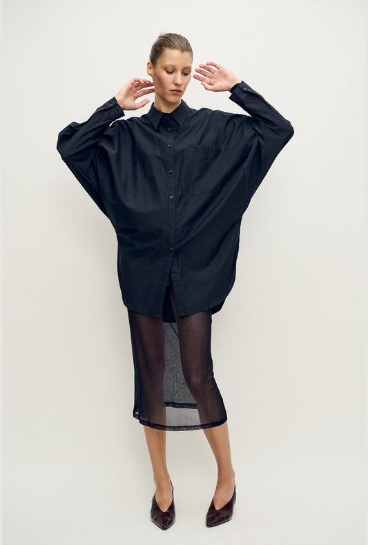 Image of a model wearing Skirts. Product name - Mesh Skirt Black in Black colour by brand - Silk Laundry