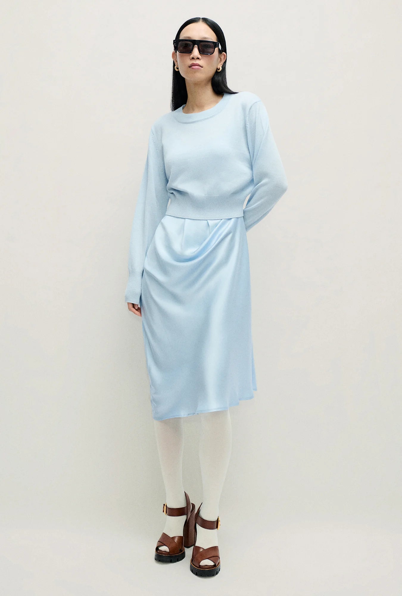 Image of a model wearing Outerwear. Product name - Wool Cropped Crewneck Cornflower in Cornflower colour by brand - Silk Laundry