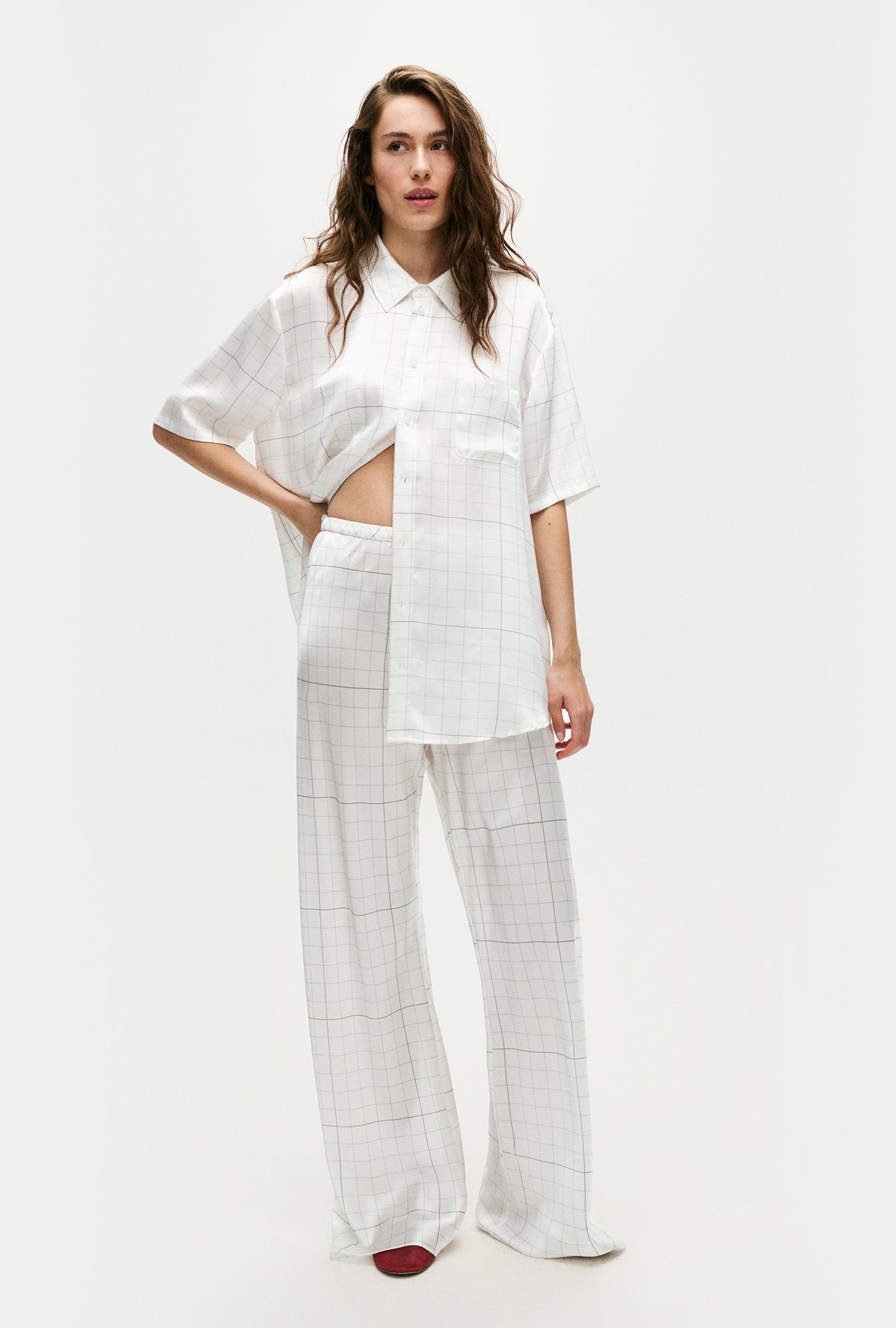 Image of a model wearing Pants. Product name - Bias Cut Pants Grid in Grid colour by brand - Silk Laundry