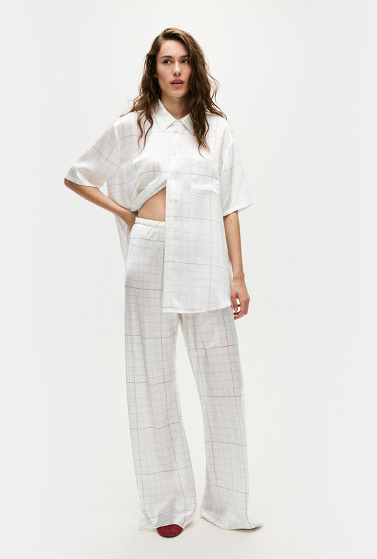 Image of a model wearing Pants. Product name - Bias Cut Pants Grid in Grid colour by brand - Silk Laundry
