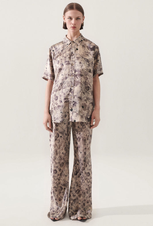 Image of a model wearing Tops. Product name - Short Sleeve Boyfriend Shirt Aster Floral in Aster Floral colour by brand - Silk Laundry