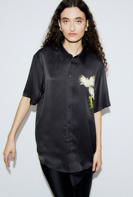 Image of a model wearing Tops. Product name - Short Sleeve Boyfriend Shirt Egret in Egret colour by brand - Silk Laundry