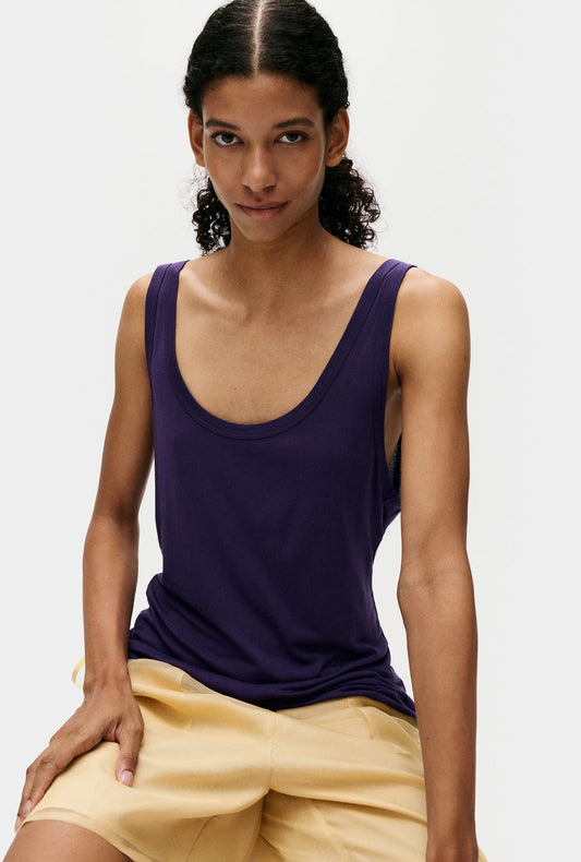 Image of a model wearing Tops. Product name - Jersey Modal Scoop Tank Nightshade in Nightshade colour by brand - Silk Laundry