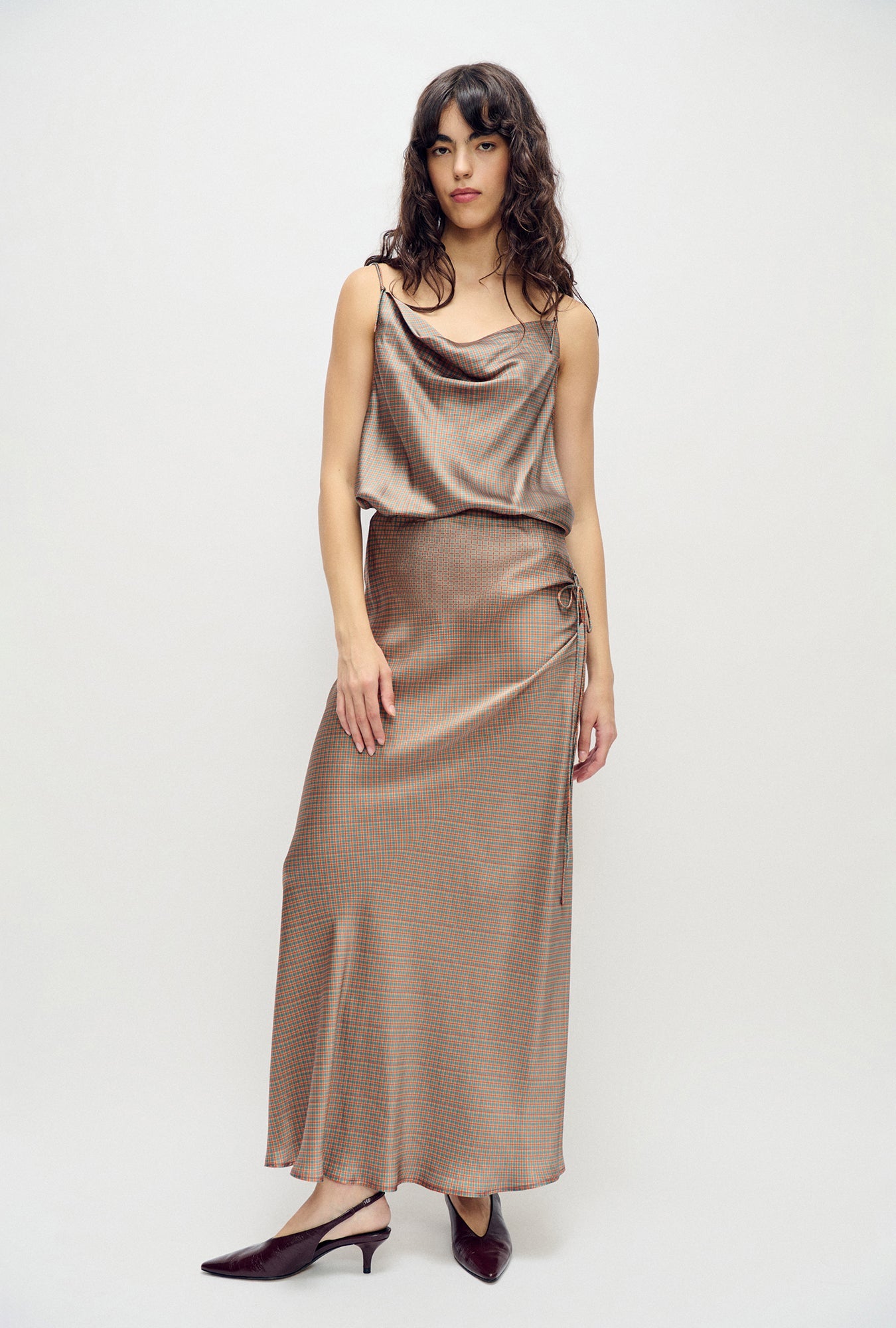 Image of a model wearing Skirts. Product name - Long Bias Cut Skirt Micro Plaid in Micro Plaid colour by brand - Silk Laundry