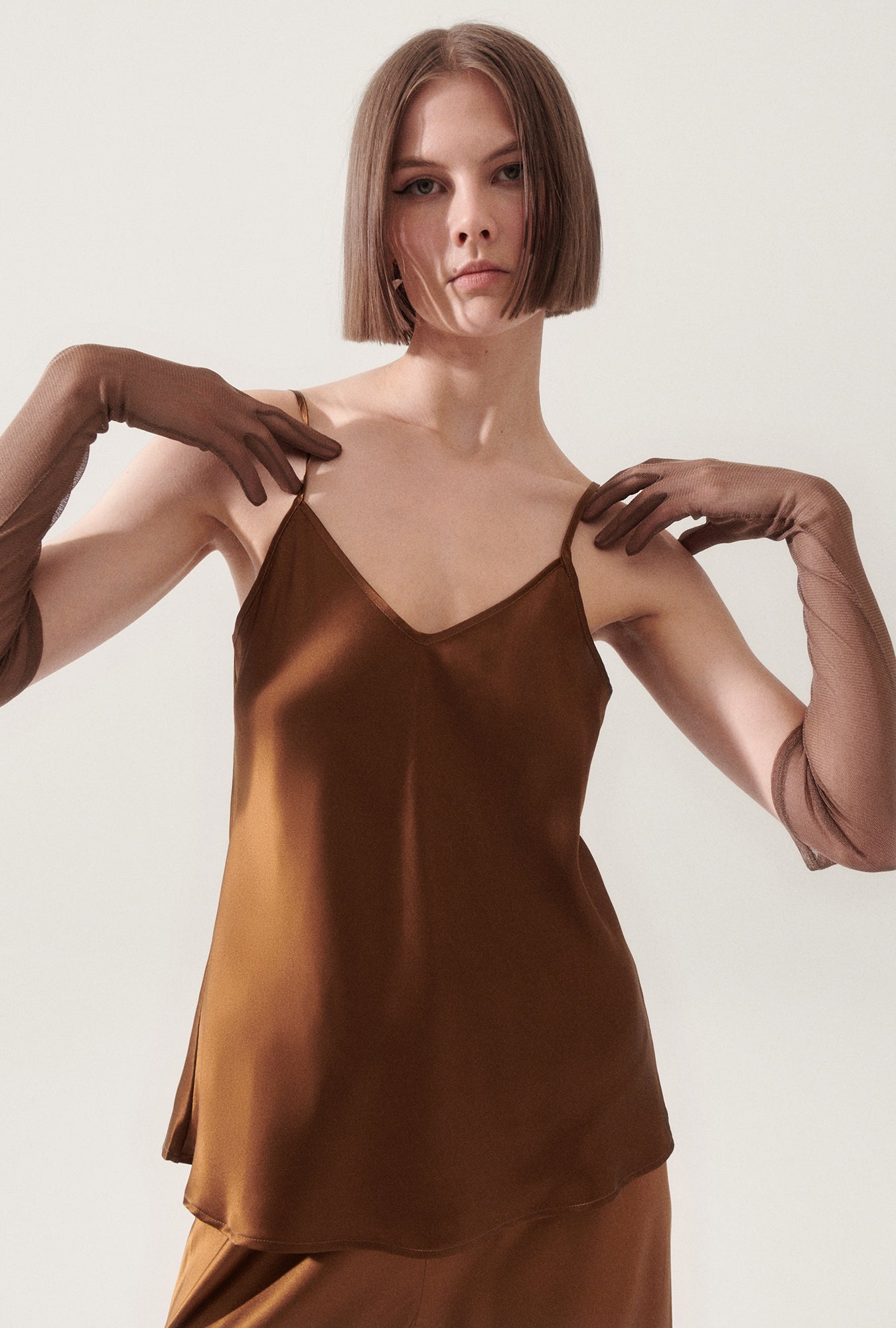 Image of a model wearing Tops. Product name - Bias Cut Cami Van Dyke Brown in Van Dyke Brown colour by brand - Silk Laundry