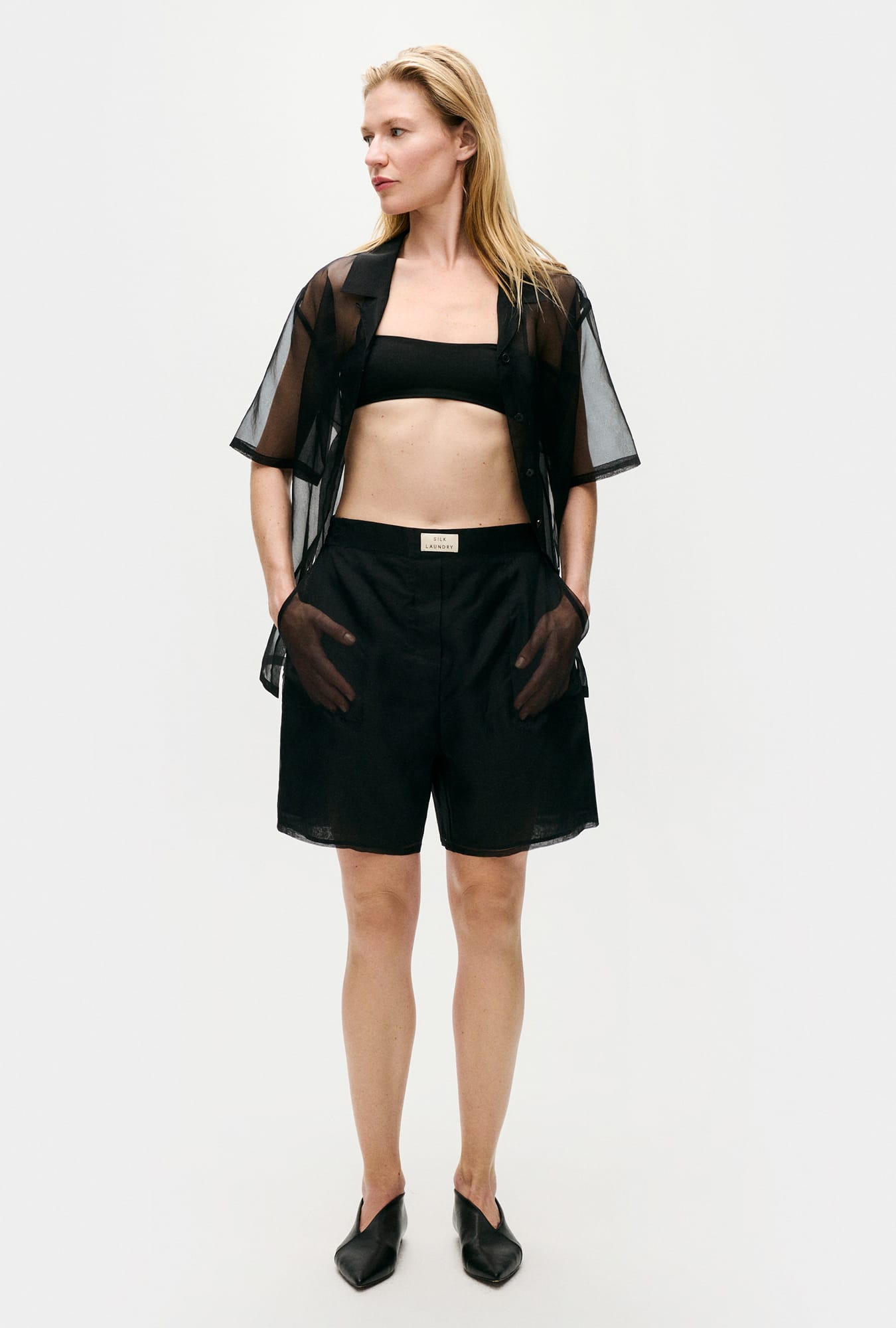 Image of a model wearing Shorts. Product name - Organza Boxer Shorts Black in Black colour by brand - Silk Laundry
