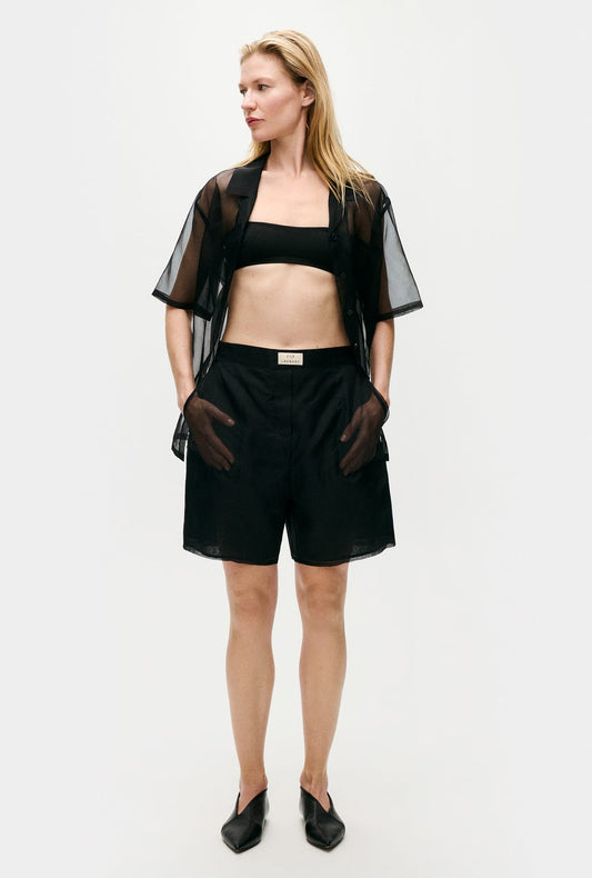 Image of a model wearing Shorts. Product name - Organza Boxer Shorts Black in Black colour by brand - Silk Laundry