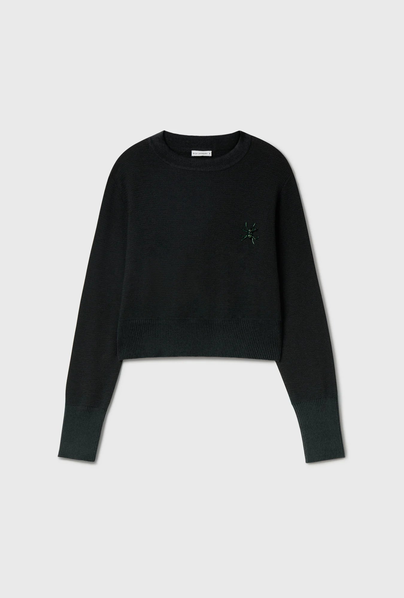 Image of a model wearing Outerwear. Product name - Wool Cropped Crewneck Black in Black colour by brand - Silk Laundry