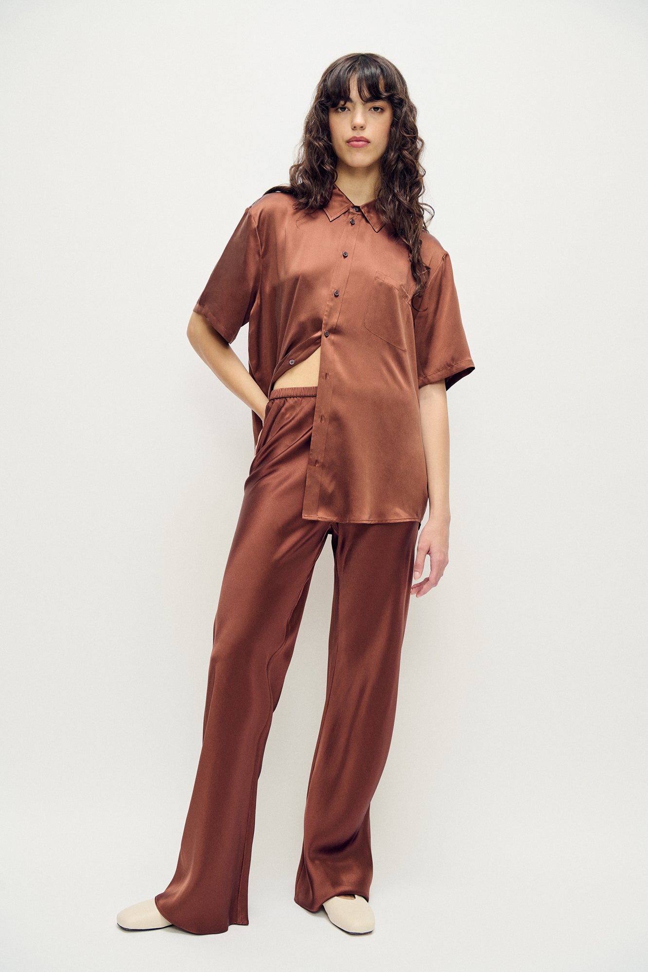 Image of a model wearing Pants. Product name - Bias Cut Pants Root in Root colour by brand - Silk Laundry