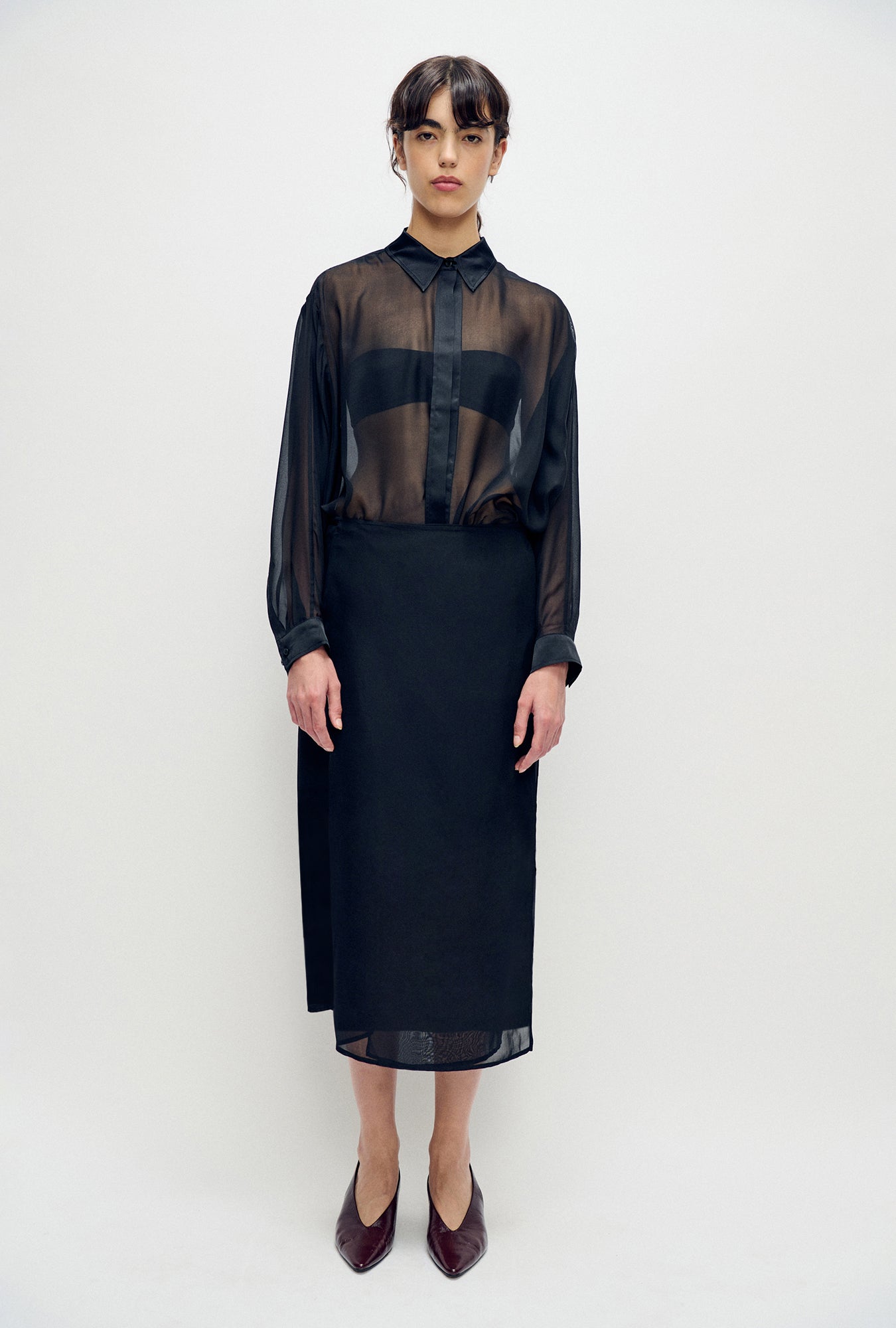Image of a model wearing Skirts. Product name - Wrap Skirt Black in Black colour by brand - Silk Laundry