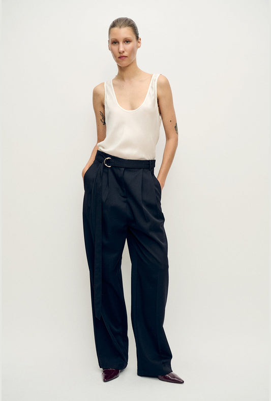 Image of a model wearing Tops. Product name - Scoop Neck Tank White in White colour by brand - Silk Laundry