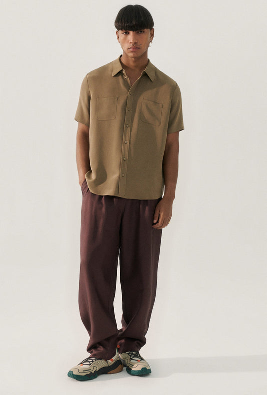 Image of a model wearing Tops. Product name - CDC Short Sleeve Boyfriend Shirt Cub in Cub colour by brand - Silk Laundry