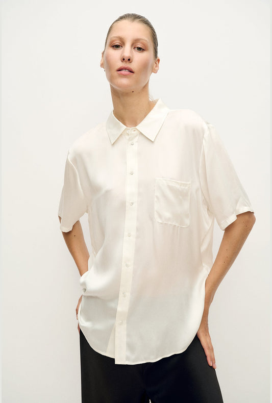 Image of a model wearing Tops. Product name - Short Sleeve Boyfriend Shirt White in White colour by brand - Silk Laundry