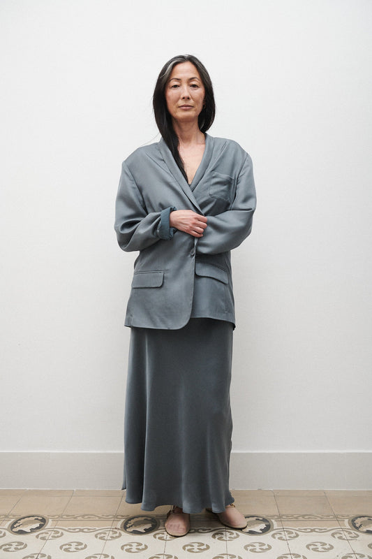 Image of a model wearing Outerwear. Product name - Twill Miami Blazer Slate in Slate colour by brand - Silk Laundry