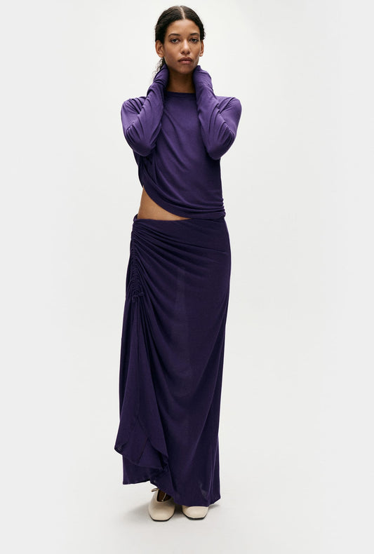 Image of a model wearing Tops. Product name - Jersey Modal Ruched Skirt Nightshade in Nightshade colour by brand - Silk Laundry