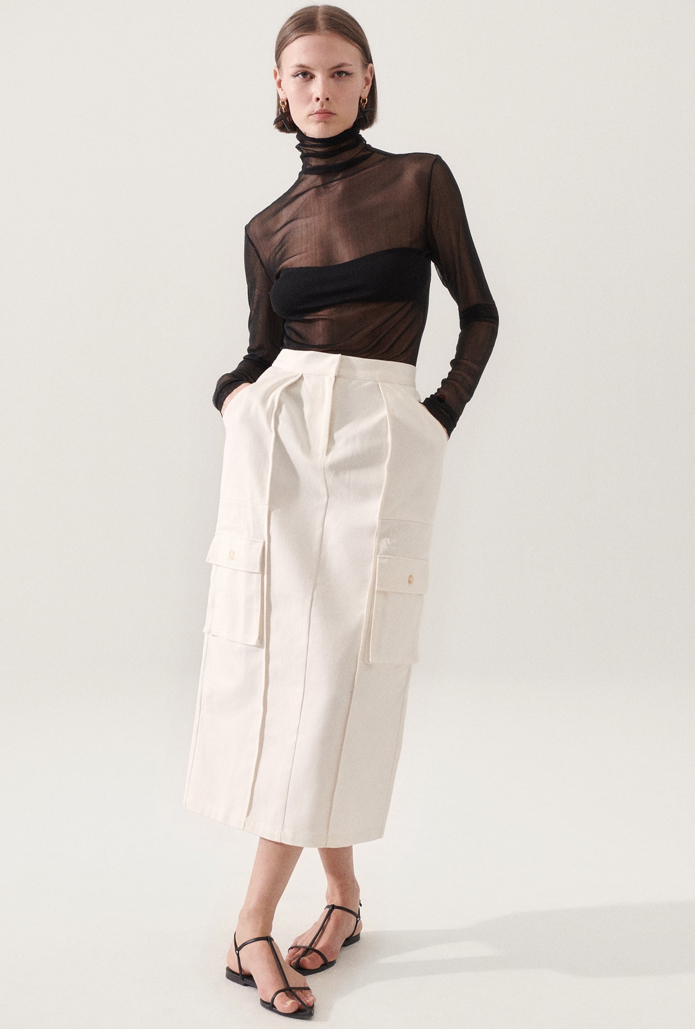 Image of a model wearing Skirts. Product name - Canvas Cargo Skirt Natural in Natural colour by brand - Silk Laundry