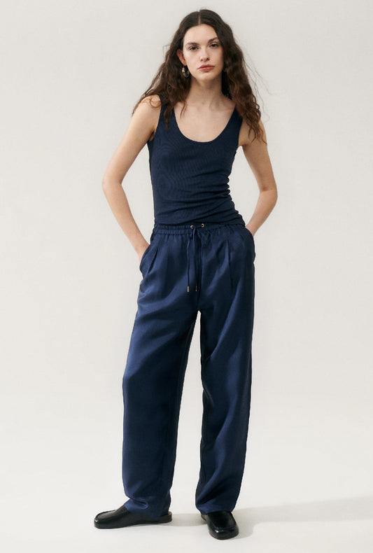Image of a model wearing Tops. Product name - Ribbed Tank Midnight in Midnight colour by brand - Silk Laundry