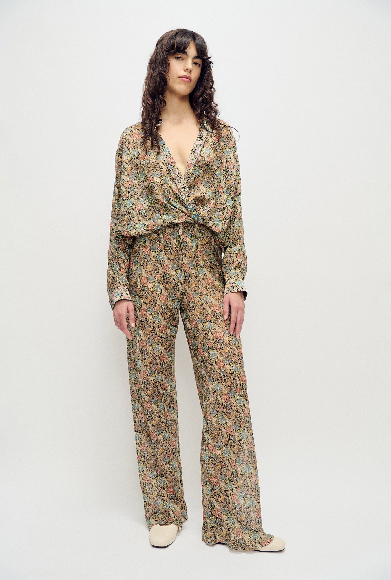 Image of a model wearing Pants. Product name - Chiffon Bias Cut Pants Sugar Floral in Sugar Floral colour by brand - Silk Laundry