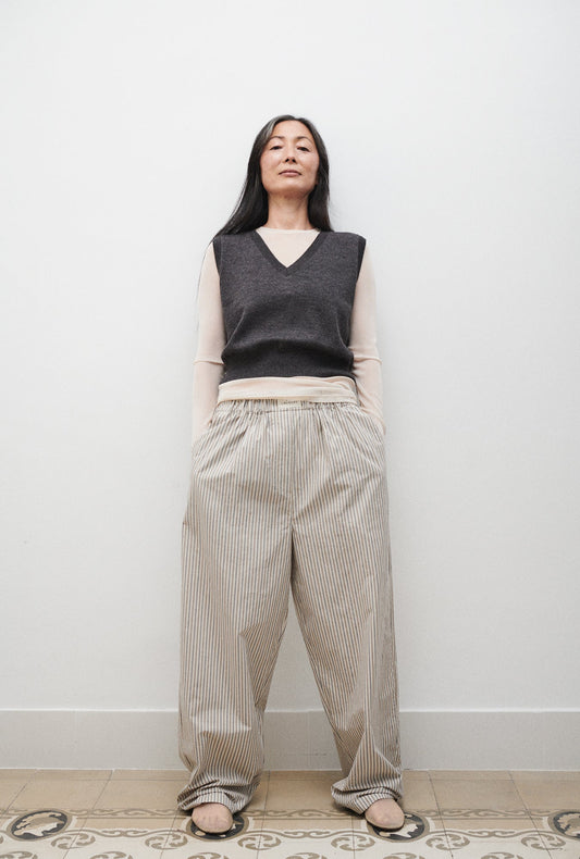 Image of a model wearing Outerwear. Product name - V-Neck Sweater Vest Granite Melange in Granite Melange colour by brand - Silk Laundry