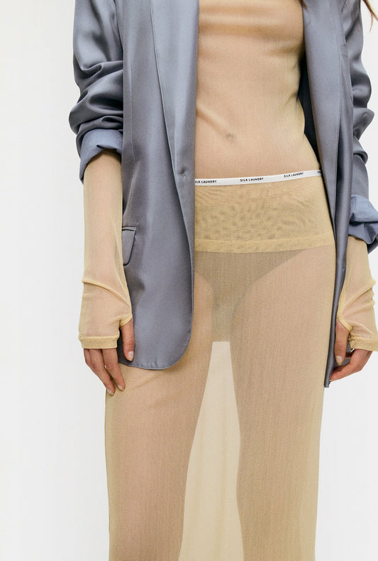 Image of a model wearing Skirts. Product name - Mesh Skirt Shell in Shell colour by brand - Silk Laundry