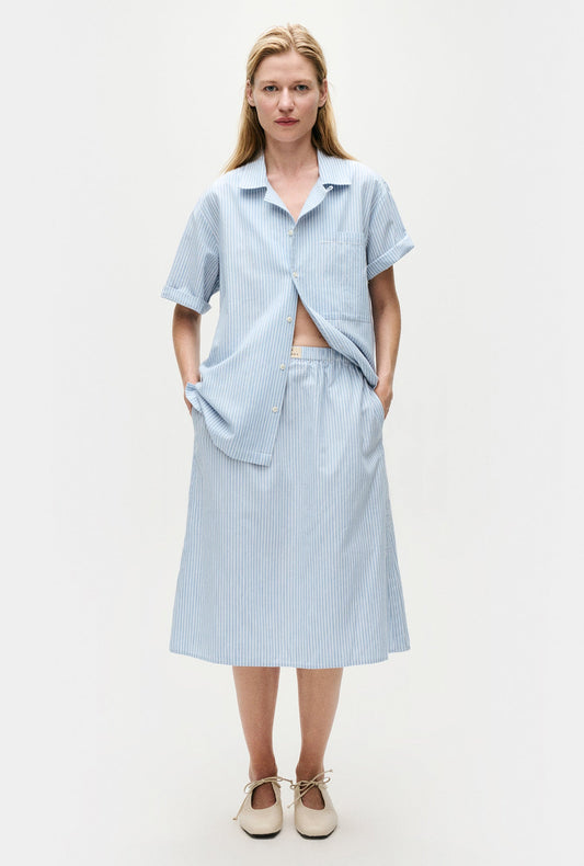 Image of a model wearing Skirts. Product name - Cotton Midi Skirt Storm Stripe in Storm Stripe colour by brand - Silk Laundry