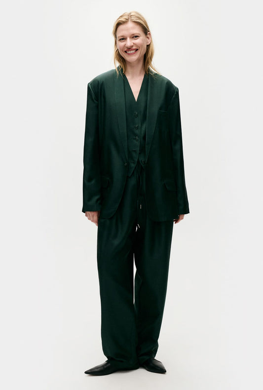 Image of a model wearing Outerwear. Product name - Twill Miami Blazer Scarab in Scarab colour by brand - Silk Laundry