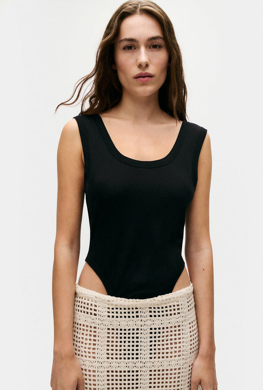 Image of a model wearing Tops. Productname: Silk Laundry Cutaway Bodysuit in Black colour by brand - Silk Laundry