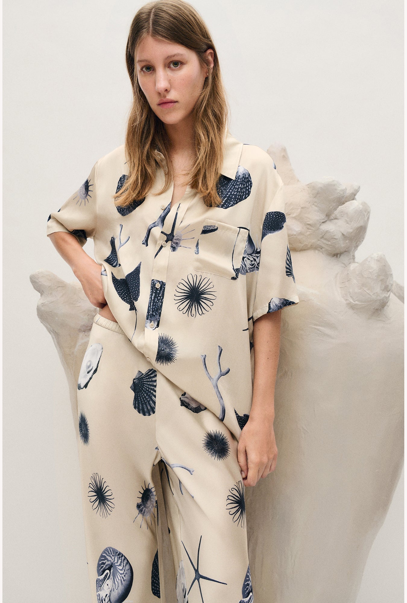 Image of a model wearing Tops. Product name - Short Sleeve Boyfriend Shirt Seashells in Seashells colour by brand - Silk Laundry