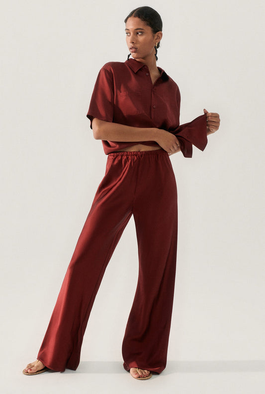 Image of a model wearing Pants. Productname: Bias Cut Pants Garnet in Garnet colour by brand - Silk Laundry