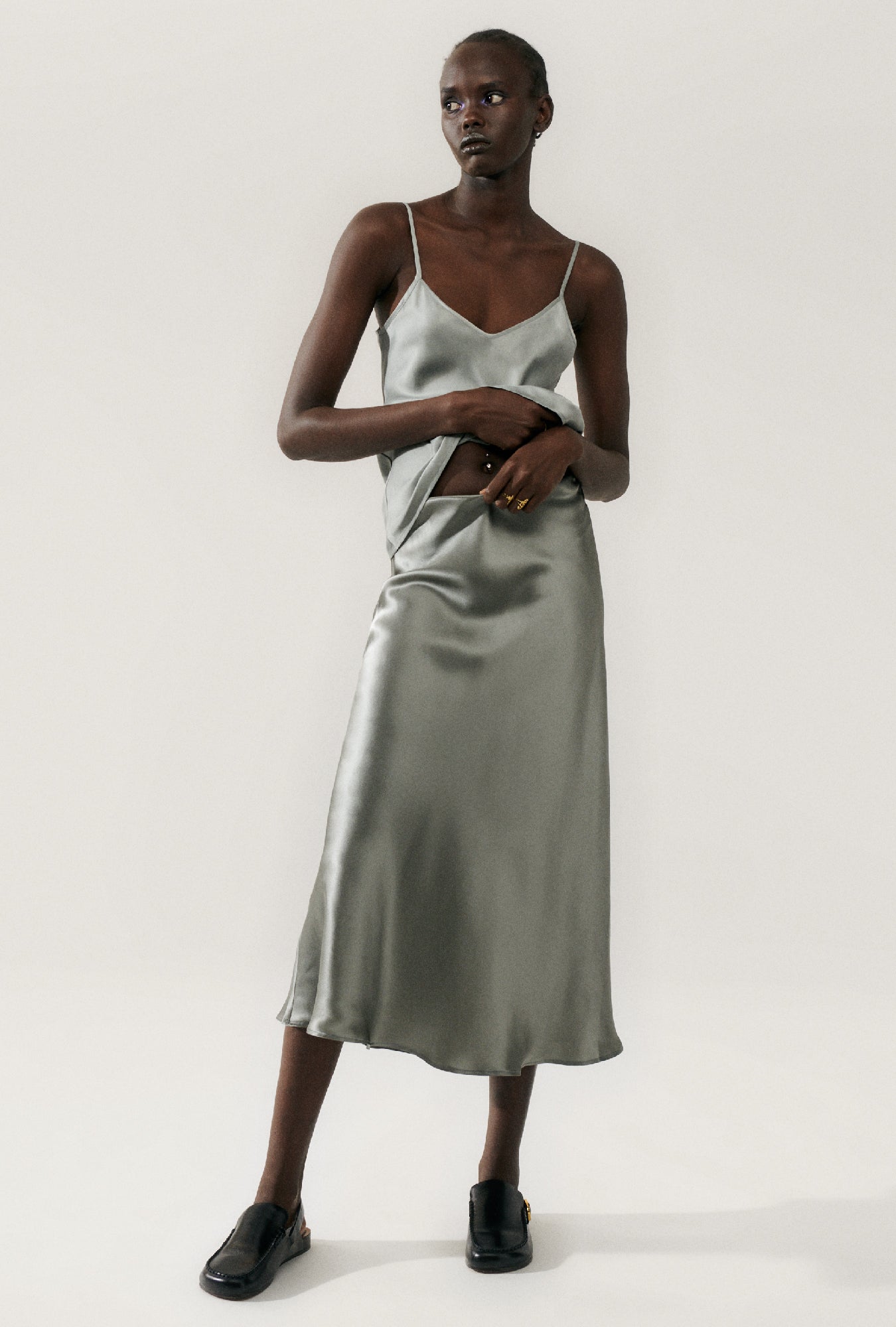 Image of a model wearing Skirts. Product name - Long Bias Cut Skirt Moon in Moon colour by brand - Silk Laundry