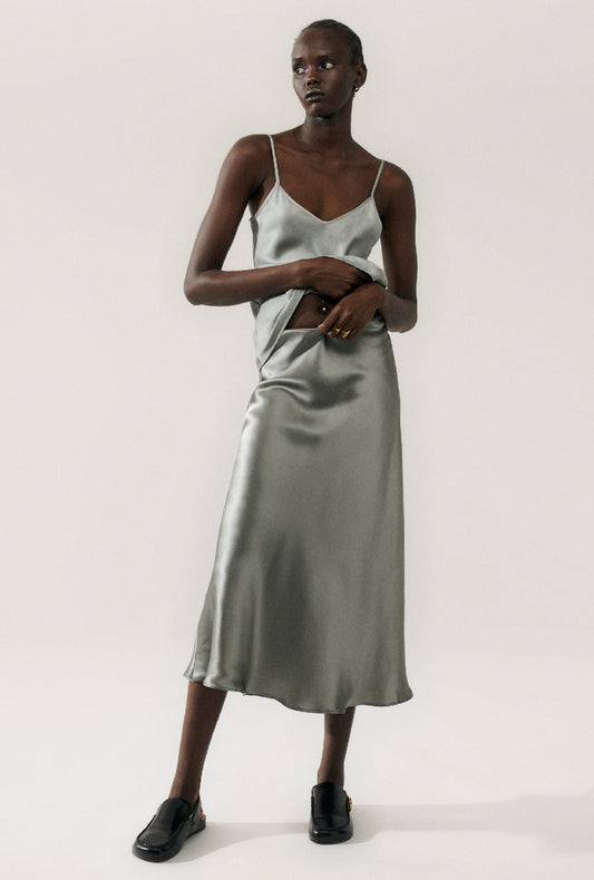 Image of a model wearing Skirts. Product name - Long Bias Cut Skirt Moon in Moon colour by brand - Silk Laundry