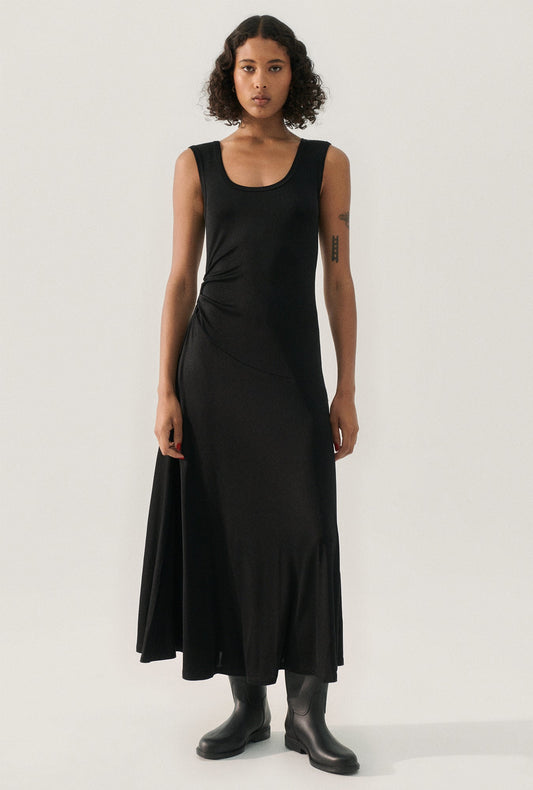 Image of a model wearing Tops. Product name - Jersey Sleeveless Dress Black in Black colour by brand - Silk Laundry