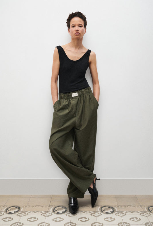 Image of a model wearing Pants. Productname: Cotton Silk Paper Bag Pants Pine in Pine colour by brand - Silk Laundry