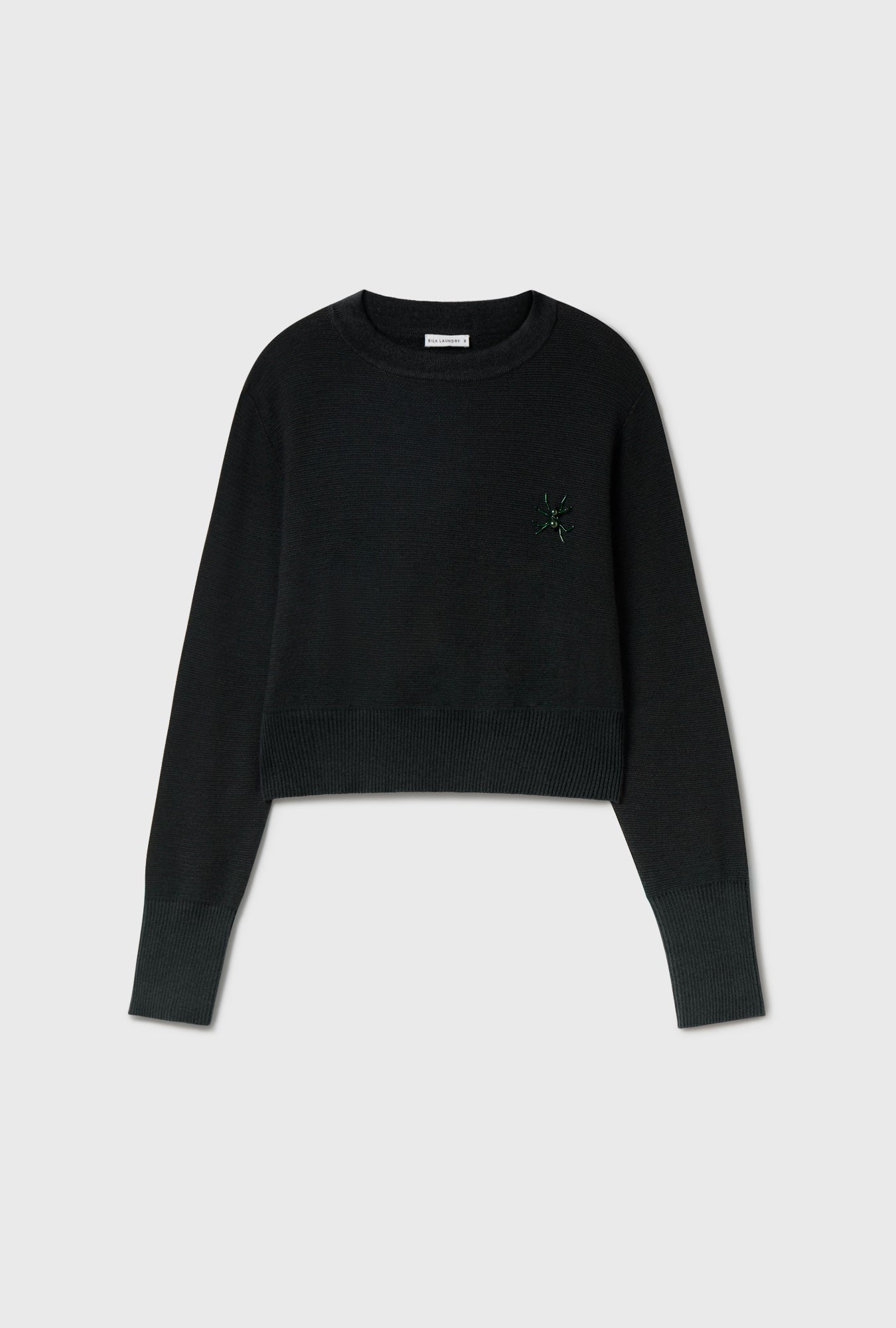 Image of a model wearing Outerwear. Product name - Wool Cropped Crewneck Black in Black colour by brand - Silk Laundry
