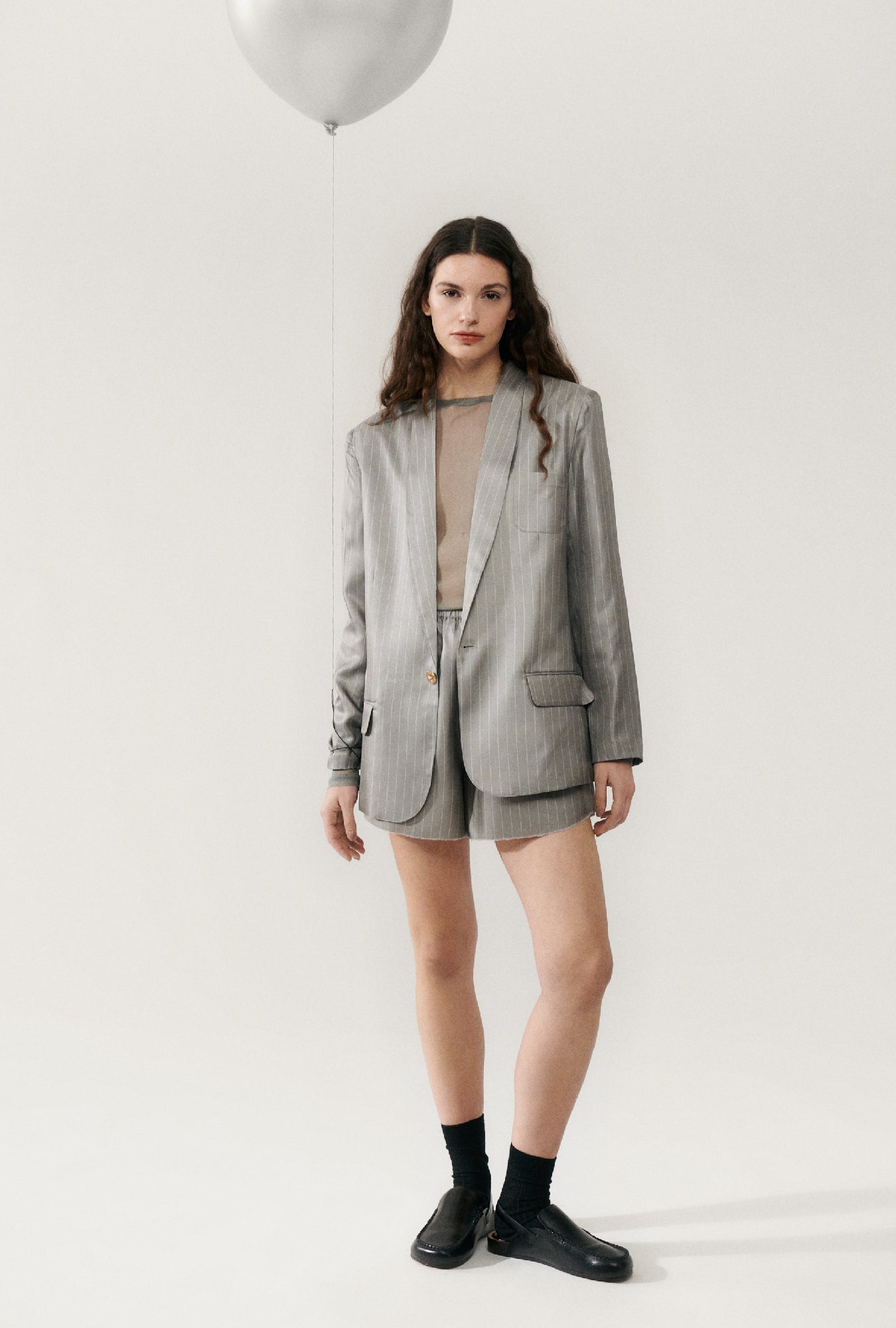 Image of a model wearing Outerwear. Product name - Twill Miami Blazer Moon Pinstripe in Moon Pinstripe colour by brand - Silk Laundry