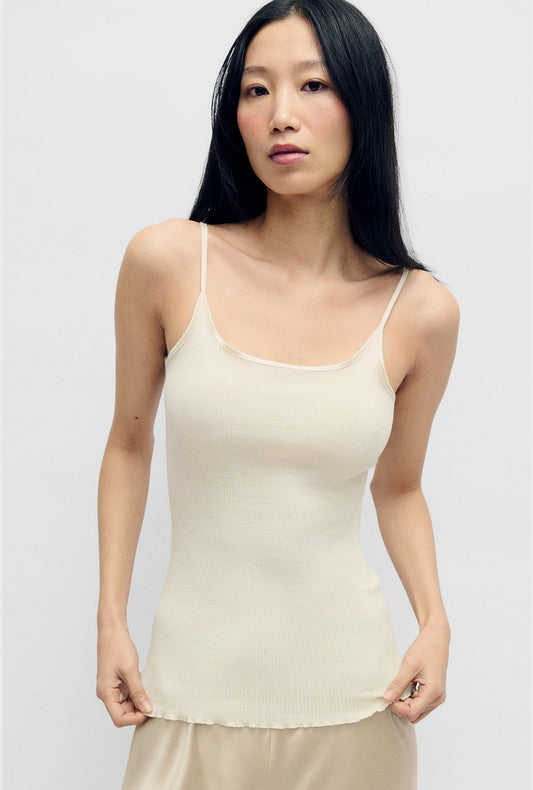 Image of a model wearing Tops. Product name - Silk Wool Ribbed Essential Cami White in White colour by brand - Silk Laundry