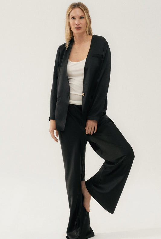 Image of a model wearing Outerwear. Product name - Collarless Blazer Black in Black colour by brand - Silk Laundry