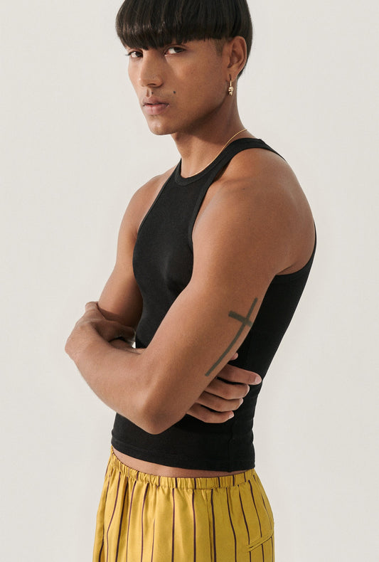 Image of a model wearing Tops. Product name - Jersey Tank Black in Black colour by brand - Silk Laundry