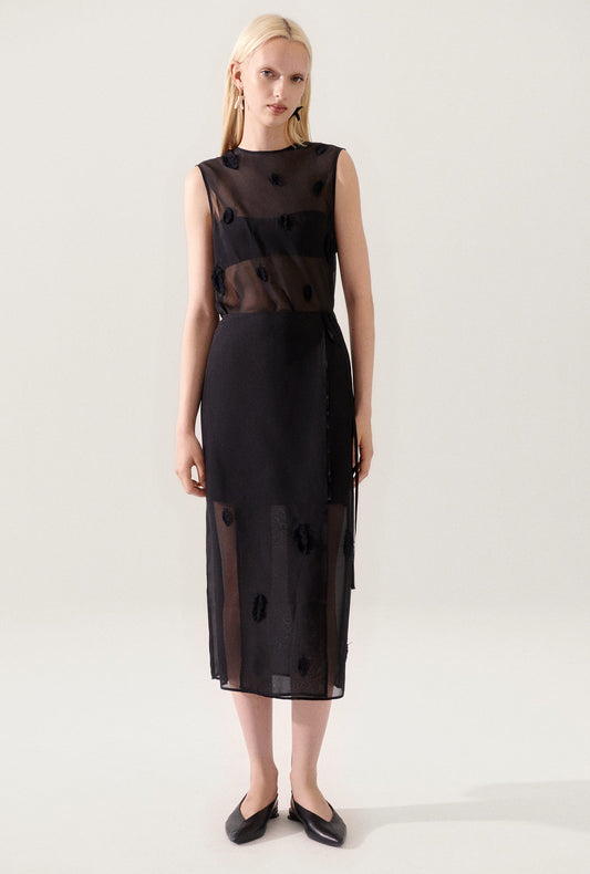 Image of a model wearing Skirts. Product name - Feather Wrap Skirt Black in Black colour by brand - Silk Laundry