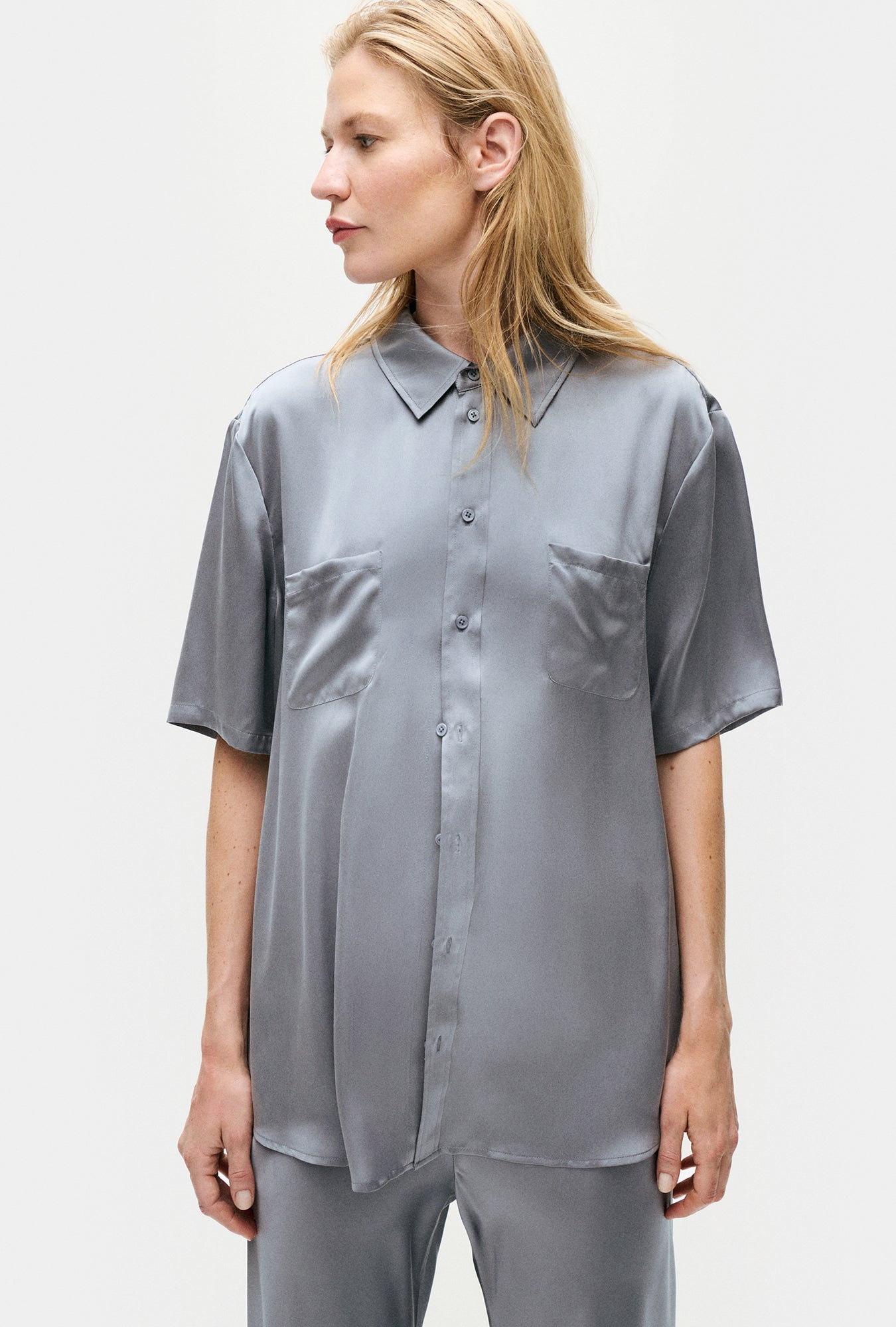 Image of a model wearing Tops. Product name - Short Sleeve Boyfriend Shirt Storm in Storm colour by brand - Silk Laundry