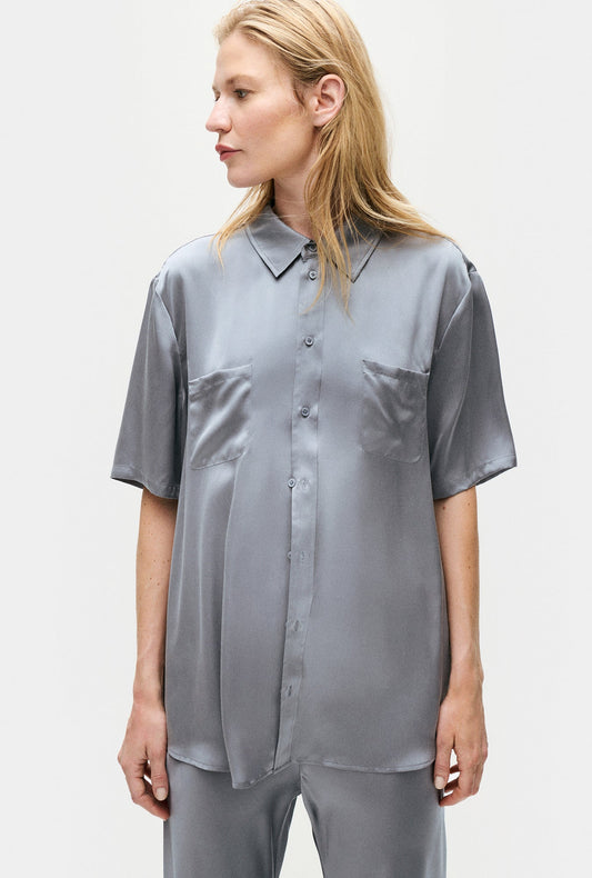 Image of a model wearing Tops. Product name - Short Sleeve Boyfriend Shirt Storm in Storm colour by brand - Silk Laundry