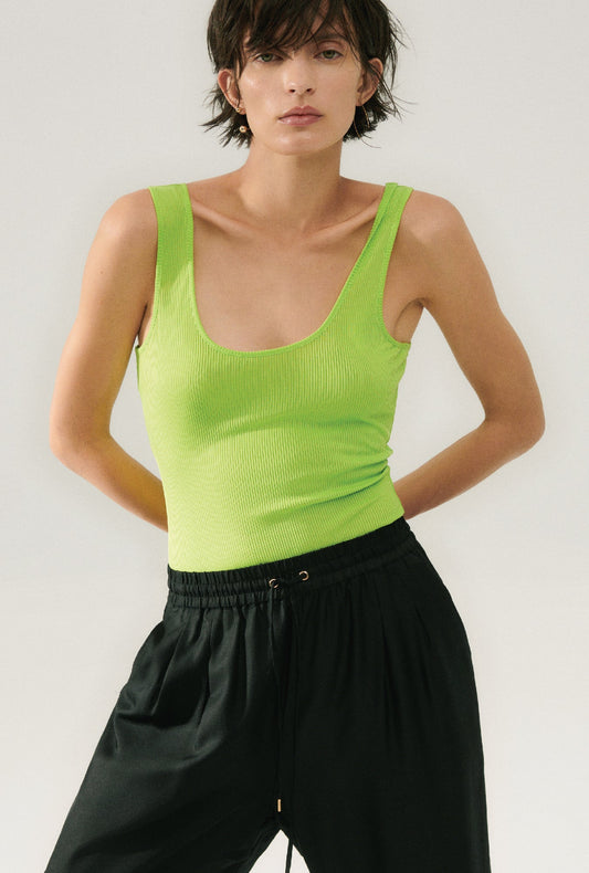 Image of a model wearing Tops. Product name - Ribbed Tank Fern in Fern colour by brand - Silk Laundry