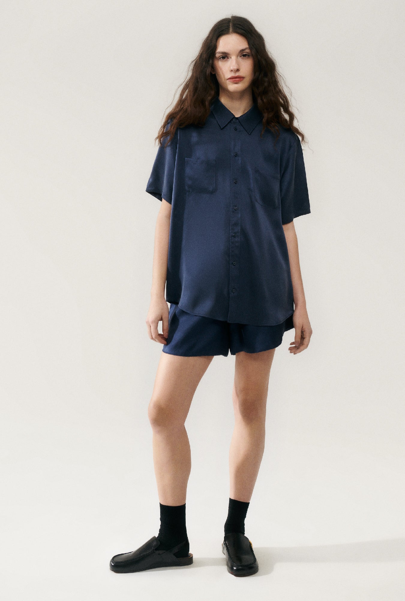 Image of a model wearing Tops. Product name - Short Sleeve Boyfriend Shirt Midnight in Midnight colour by brand - Silk Laundry