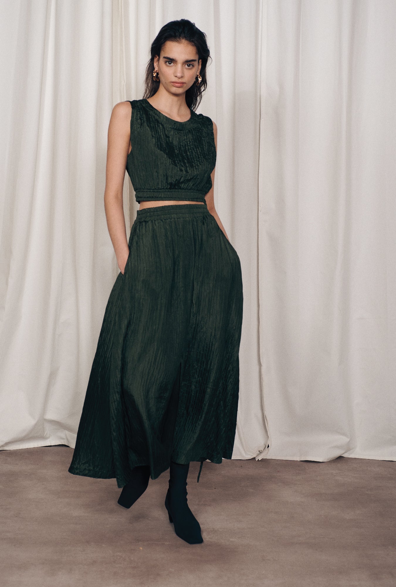 Image of a model wearing Skirts. Product name - Crinkle Skirt Cedar in Cedar colour by brand - Silk Laundry