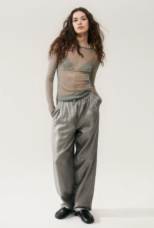 Image of a model wearing Pants. Product name - Twill Slouch Pants Moon Pinstripe in Moon Pinstripe colour by brand - Silk Laundry