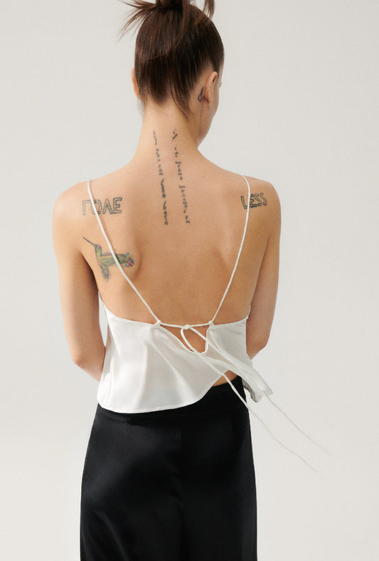 Image of a model wearing Tops. Productname: Carrie Cami White in White colour by brand - Silk Laundry