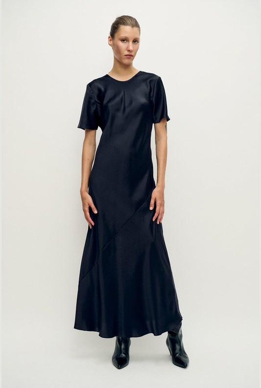 Image of a model wearing Tops. Productname: Short Sleeve Bias Dress Black in Black colour by brand - Silk Laundry