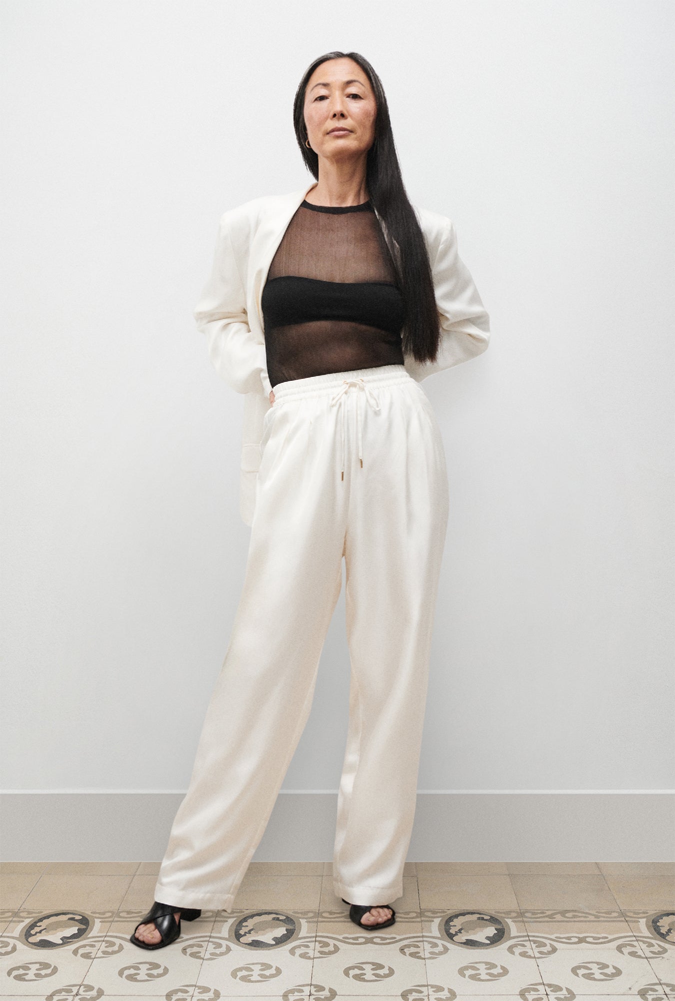 Image of a model wearing Pants. Product name - Twill Slouch Pants White in White colour by brand - Silk Laundry